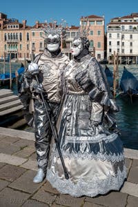 People in costume at the Venice carnival in front of the Madonna della Salute.