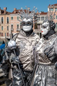 People in costume at the Venice carnival in front of the Madonna della Salute.