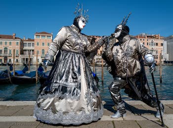 People in costume at the Venice carnival in front of the Madonna della Salute.