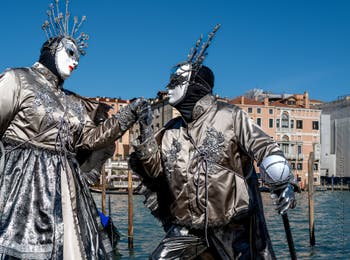 People in costume at the Venice carnival in front of the Madonna della Salute.