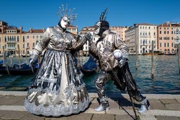 People in costume at the Venice carnival in front of the Madonna della Salute.