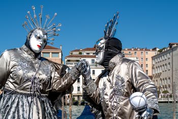 People in costume at the Venice carnival in front of the Madonna della Salute.