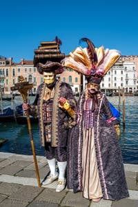 People in costume at the Venice carnival in front of the Madonna della Salute.