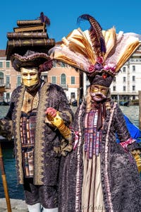 People in costume at the Venice carnival in front of the Madonna della Salute.