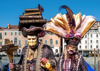 People in costume at the Venice carnival in front of the Madonna della Salute.