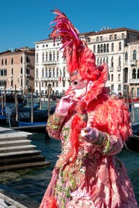 People in costume at the Venice carnival in front of the Madonna della Salute.