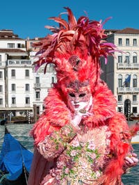 People in costume at the Venice carnival in front of the Madonna della Salute.