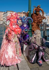 People in costume at the Venice carnival in front of the Madonna della Salute.