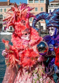 People in costume at the Venice carnival in front of the Madonna della Salute.