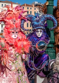 People in costume at the Venice carnival in front of the Madonna della Salute.