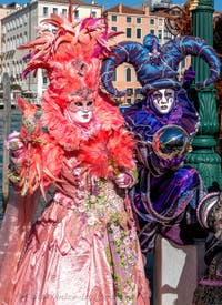 People in costume at the Venice carnival in front of the Madonna della Salute.