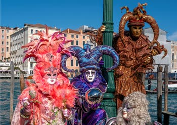 People in costume at the Venice carnival in front of the Madonna della Salute.