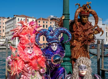 People in costume at the Venice carnival in front of the Madonna della Salute.