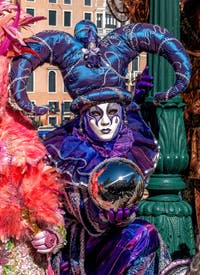 People in costume at the Venice carnival in front of the Madonna della Salute.