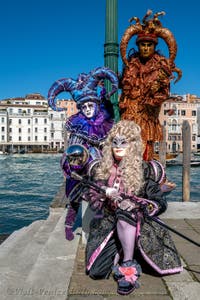 People in costume at the Venice carnival in front of the Madonna della Salute.