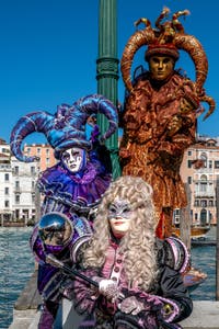 People in costume at the Venice carnival in front of the Madonna della Salute.