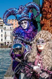 People in costume at the Venice carnival in front of the Madonna della Salute.