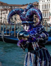 People in costume at the Venice carnival in front of the Madonna della Salute.