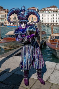 People in costume at the Venice carnival in front of the Madonna della Salute.