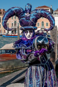 People in costume at the Venice carnival in front of the Madonna della Salute.