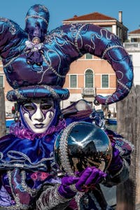 People in costume at the Venice carnival in front of the Madonna della Salute.