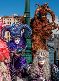 People in costume at the Venice carnival in front of the Madonna della Salute.