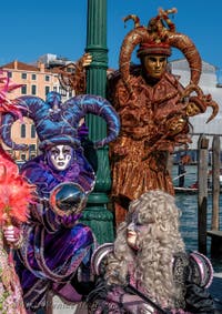 People in costume at the Venice carnival in front of the Madonna della Salute.