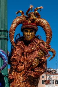 People in costume at the Venice carnival in front of the Madonna della Salute.