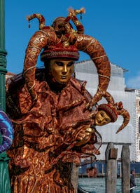 People in costume at the Venice carnival in front of the Madonna della Salute.