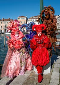 People in costume at the Venice carnival in front of the Madonna della Salute.