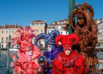 People in costume at the Venice carnival in front of the Madonna della Salute.