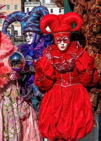 People in costume at the Venice carnival in front of the Madonna della Salute.