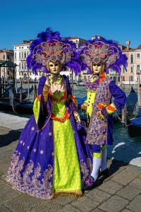 People in costume at the Venice carnival in front of the Madonna della Salute.