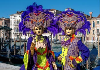 People in costume at the Venice carnival in front of the Madonna della Salute.