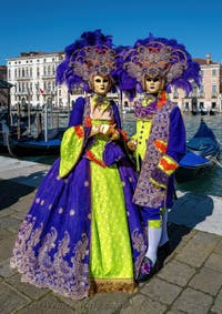 People in costume at the Venice carnival in front of the Madonna della Salute.