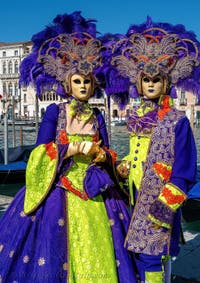 People in costume at the Venice carnival in front of the Madonna della Salute.