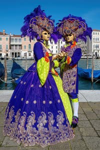 People in costume at the Venice carnival in front of the Madonna della Salute.