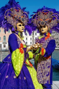 People in costume at the Venice carnival in front of the Madonna della Salute.