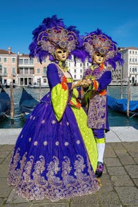 People in costume at the Venice carnival in front of the Madonna della Salute.