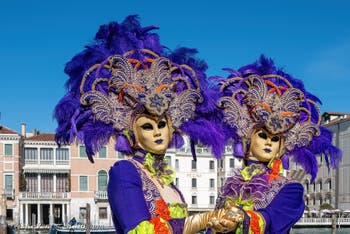 People in costume at the Venice carnival in front of the Madonna della Salute.