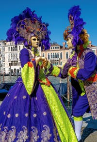 People in costume at the Venice carnival in front of the Madonna della Salute.