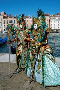 People in costume at the Venice carnival in front of the Madonna della Salute.