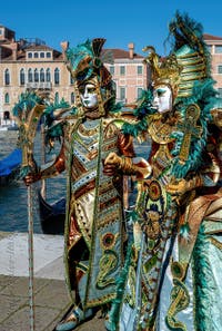 People in costume at the Venice carnival in front of the Madonna della Salute.