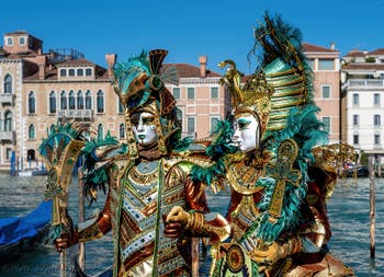 People in costume at the Venice carnival in front of the Madonna della Salute.