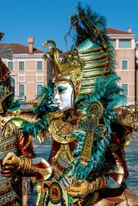 People in costume at the Venice carnival in front of the Madonna della Salute.