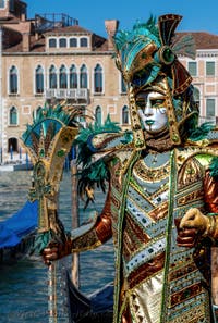 People in costume at the Venice carnival in front of the Madonna della Salute.