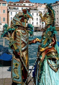 People in costume at the Venice carnival in front of the Madonna della Salute.