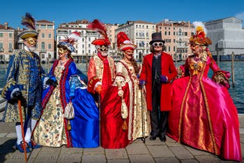 People in costume at the Venice carnival in front of the Madonna della Salute.