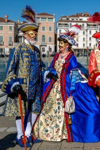 People in costume at the Venice carnival in front of the Madonna della Salute.