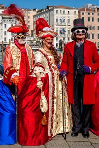 People in costume at the Venice carnival in front of the Madonna della Salute.